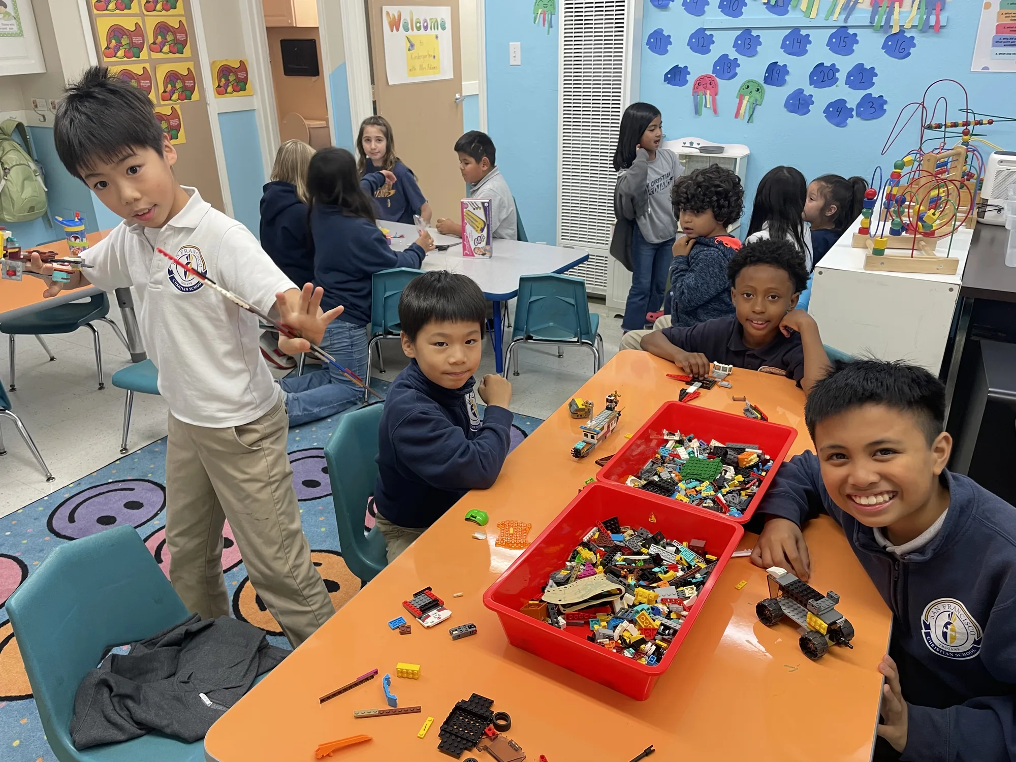 Students building with Legos in the after-care activity room