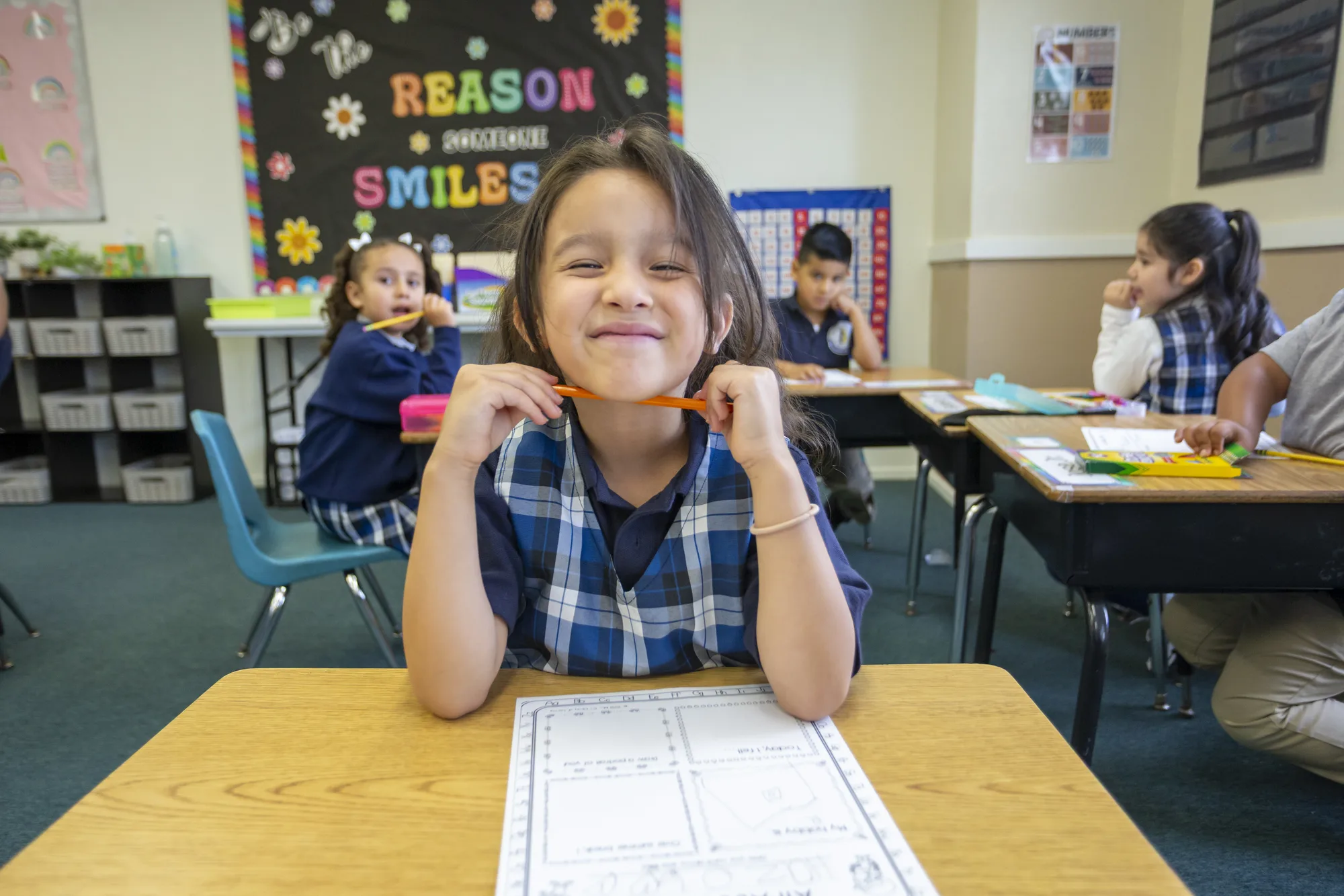 First graders engaged at their desks in the classroom