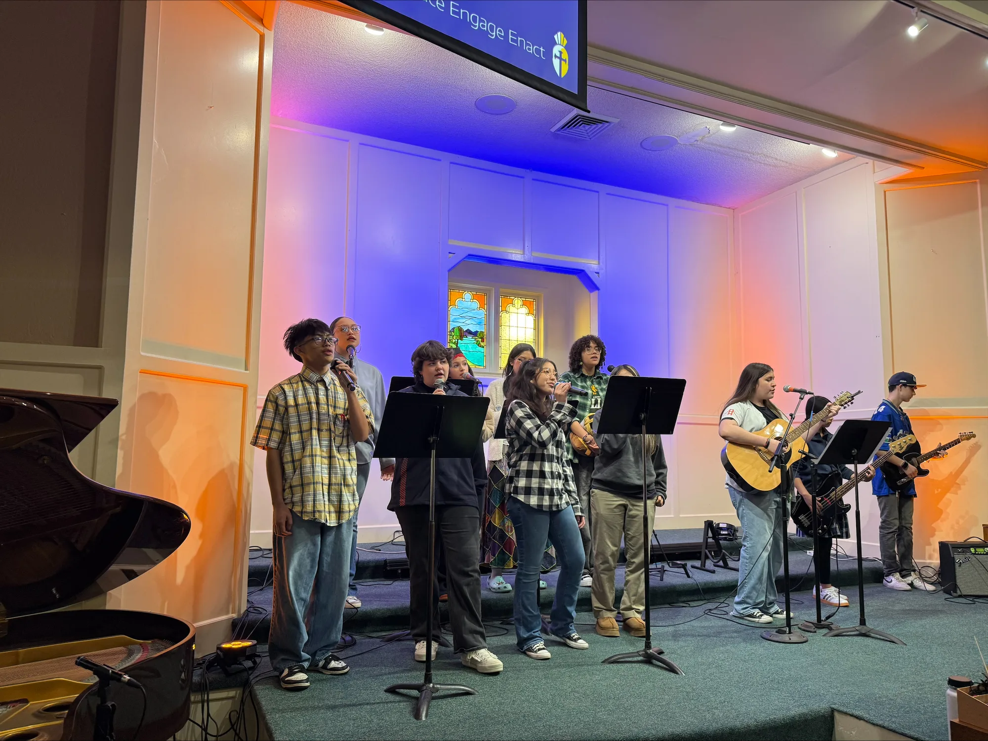 The high school student worship band playing in warm atmospheric light
