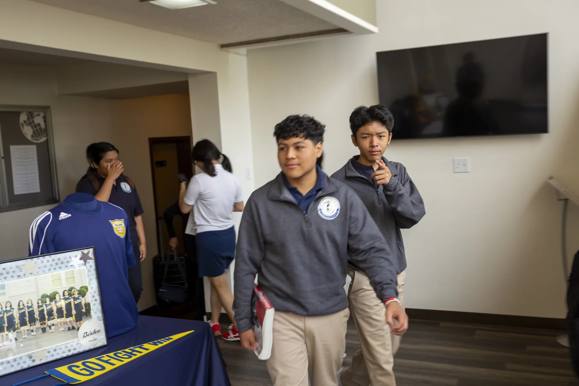 Two middle school students smiling in the school lobby