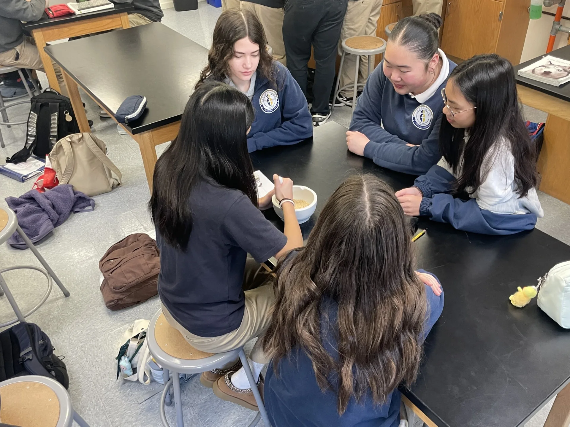 Two middle school students collaborating at a microscope